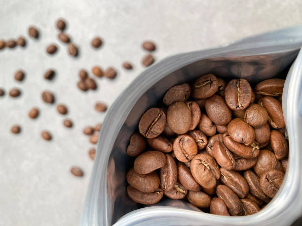 Coffee beans package. High angle view open coffee bean packet with copy space