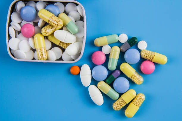 Tablets, pills and capsules on a blue Background